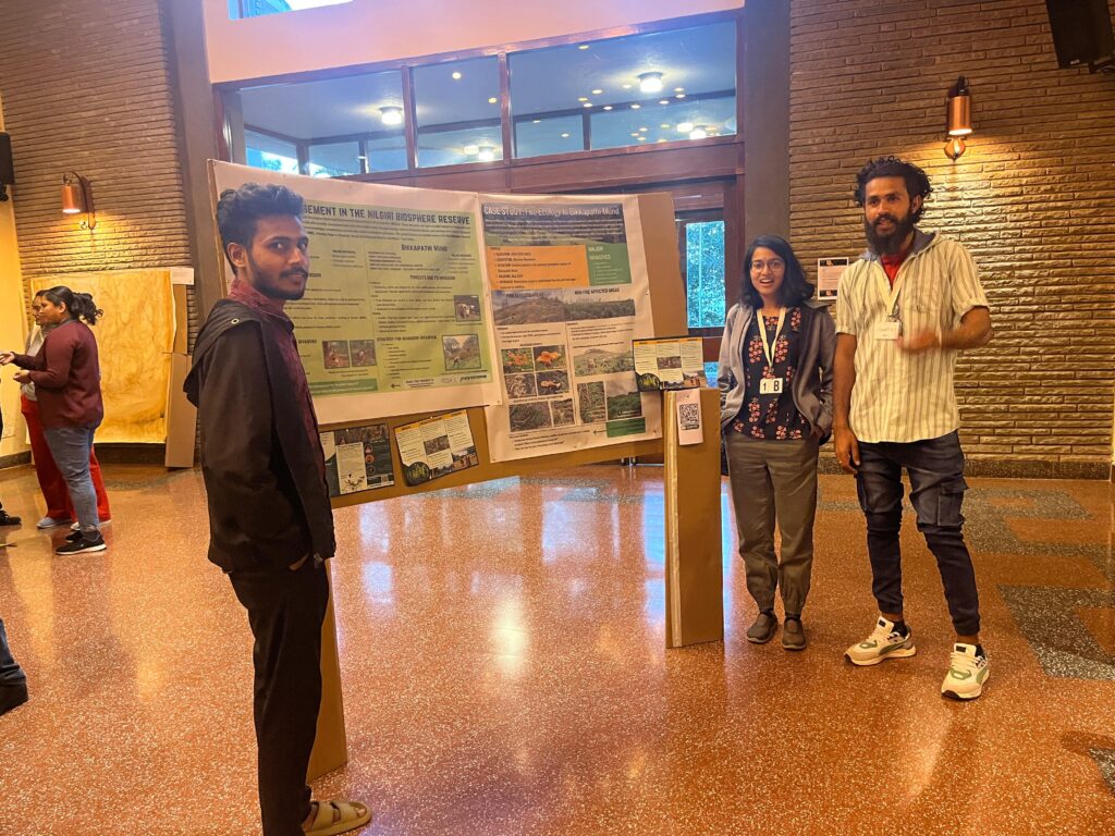 Team presenting posters on invasive management and fire ecology in Network Mela