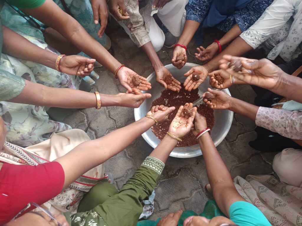 Women making Mahua laddus together