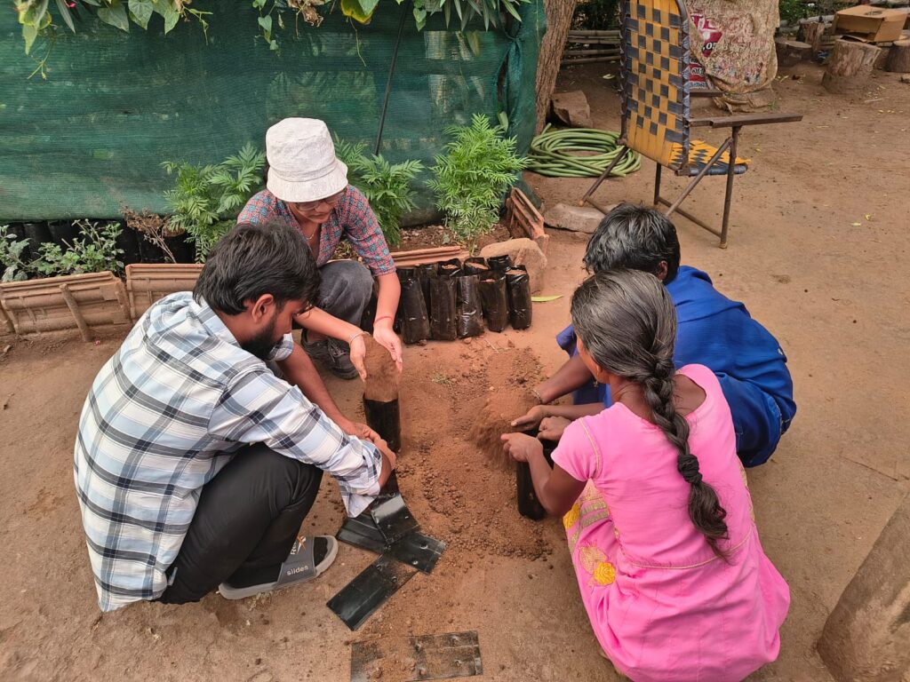 Helping Akkas in filling the Packets for backyard nursery