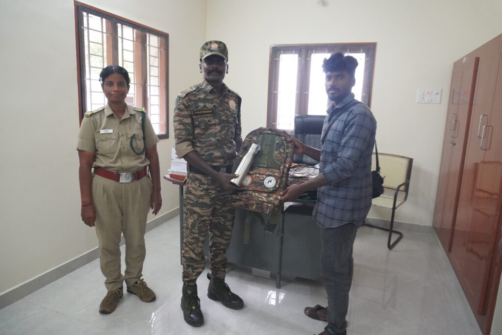 Mathesan distributing camouflage bag and water bottle to Anti Poaching Watcher in TN Palayam range